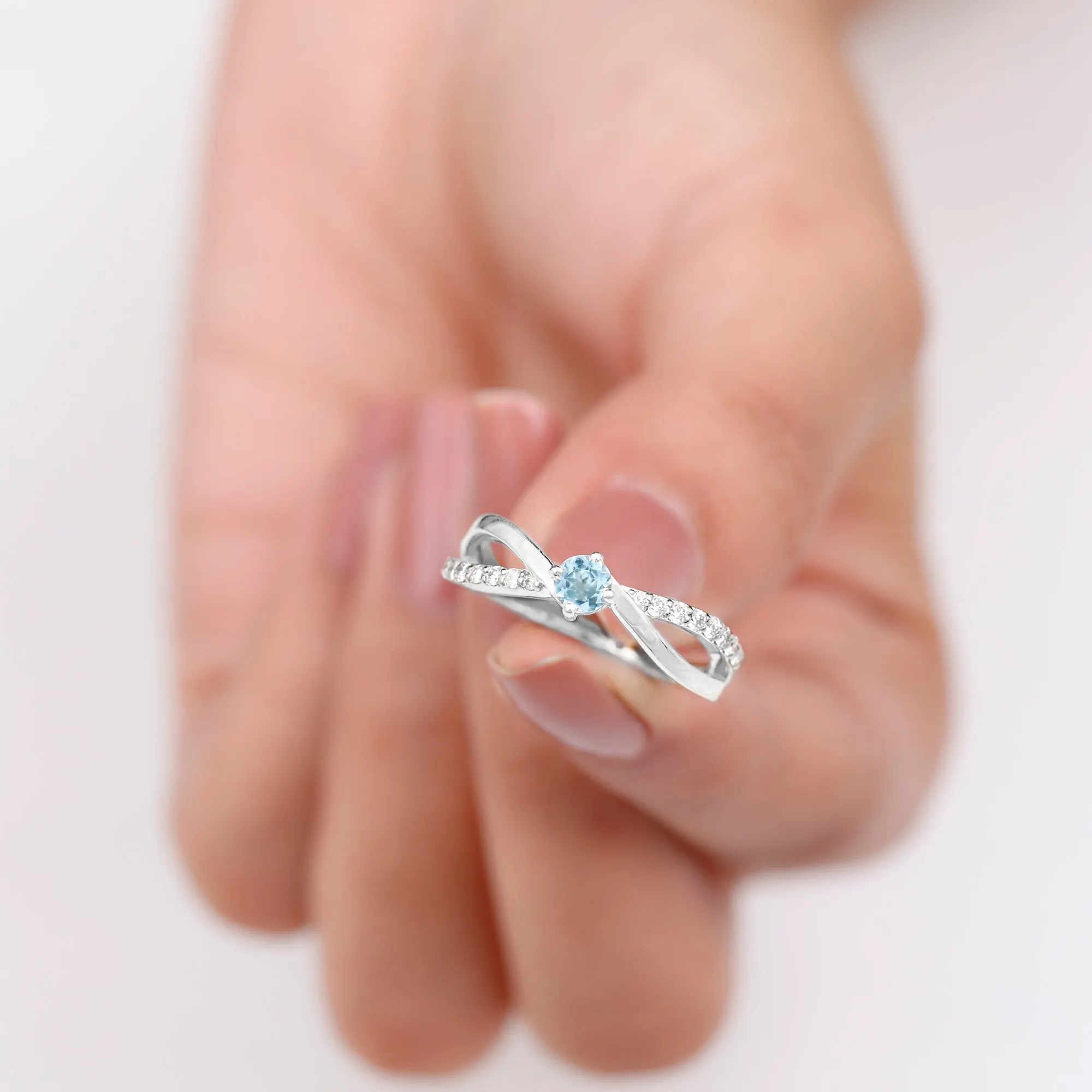 1/2 CT Sky Blue Topaz Solitaire and Diamond Gold Infinity Ring
