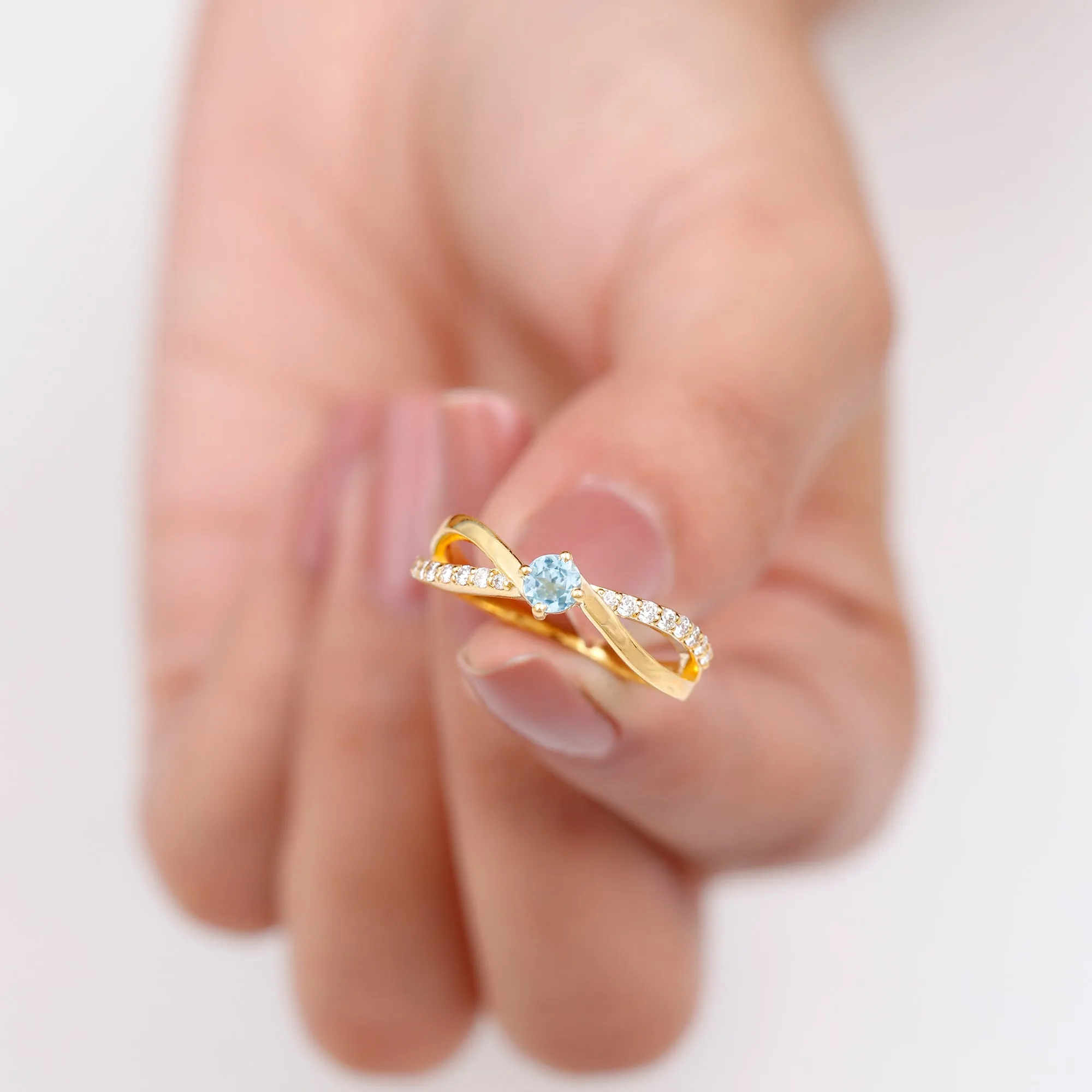 1/2 CT Sky Blue Topaz Solitaire and Diamond Gold Infinity Ring